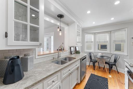 Granite counters, stainless appliances, classic cabinetry with glass-front accents.