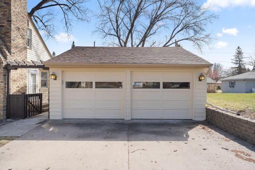 Generous sized 2-car garage. Several built-in cabinets and work bench inside the garage.