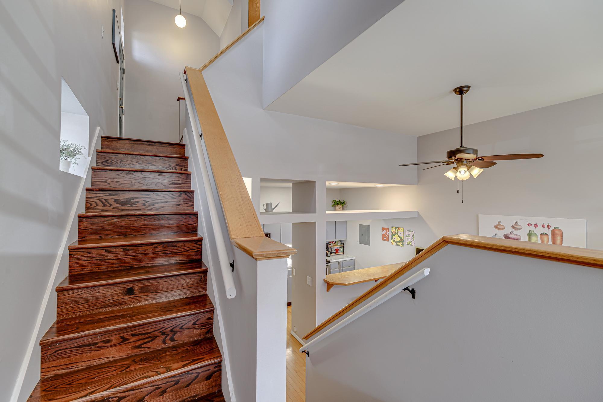These stairs go down to the dining/kitchen area and up to the bedroom and bathroom