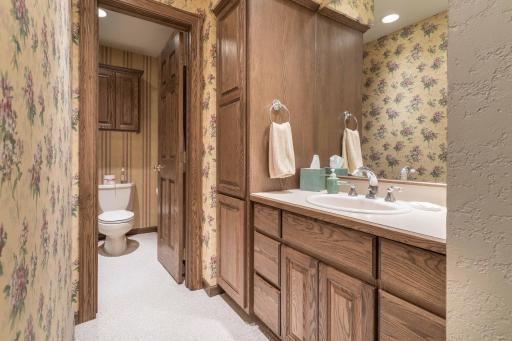 Separate toilet room with lots of cabinetry and 3/4 bath.