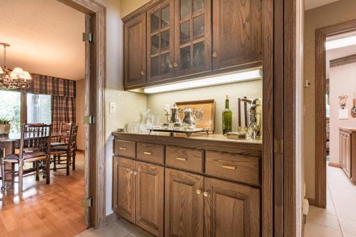 Butlers pantry with cabinetry and lighting.