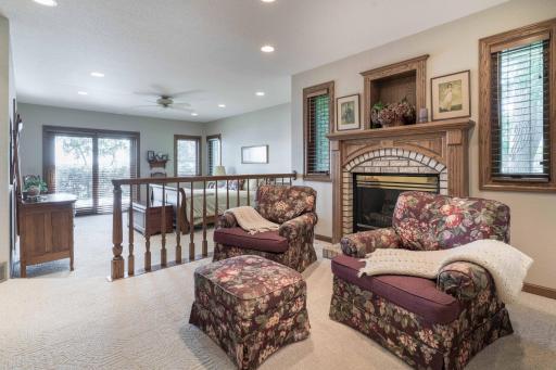 Primary bedroom with natural gas fireplace with Brick hearth. complete with private sitting area for those cold winter nights
and lots of windows.