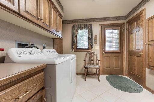 Large laundry with separate entrance and coat closet and tile floor.