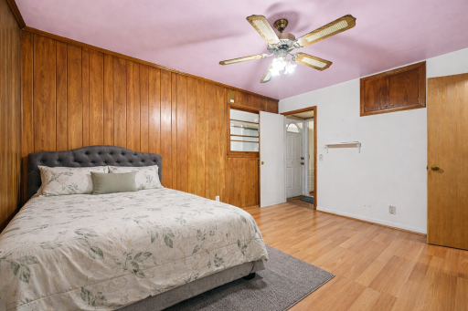 Spacious bedroom with attached bath with ample natural light and versatile layout potential.