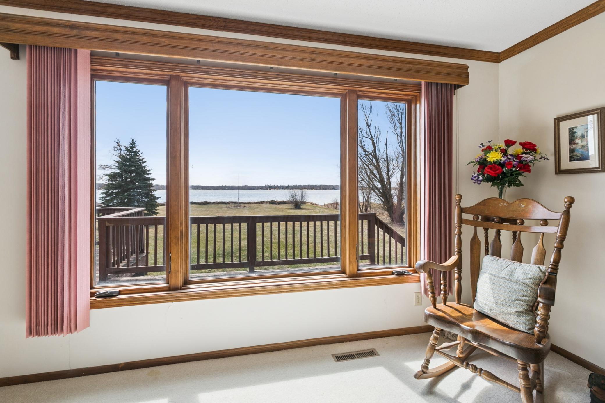View from the living room. Custom cornice on this large picture window and kitchen slider.