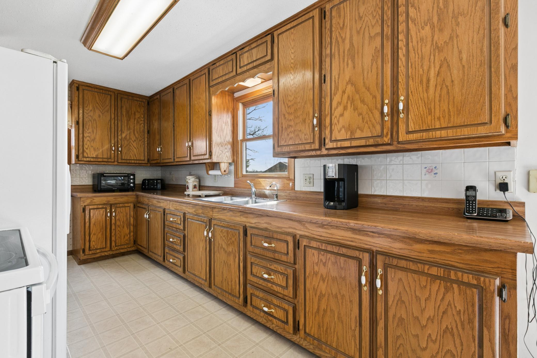 Owners stripped down the original (pink) oak cabinets and restored to their natural grain. Tons of counter space and storage for your kitchen gadgets.
