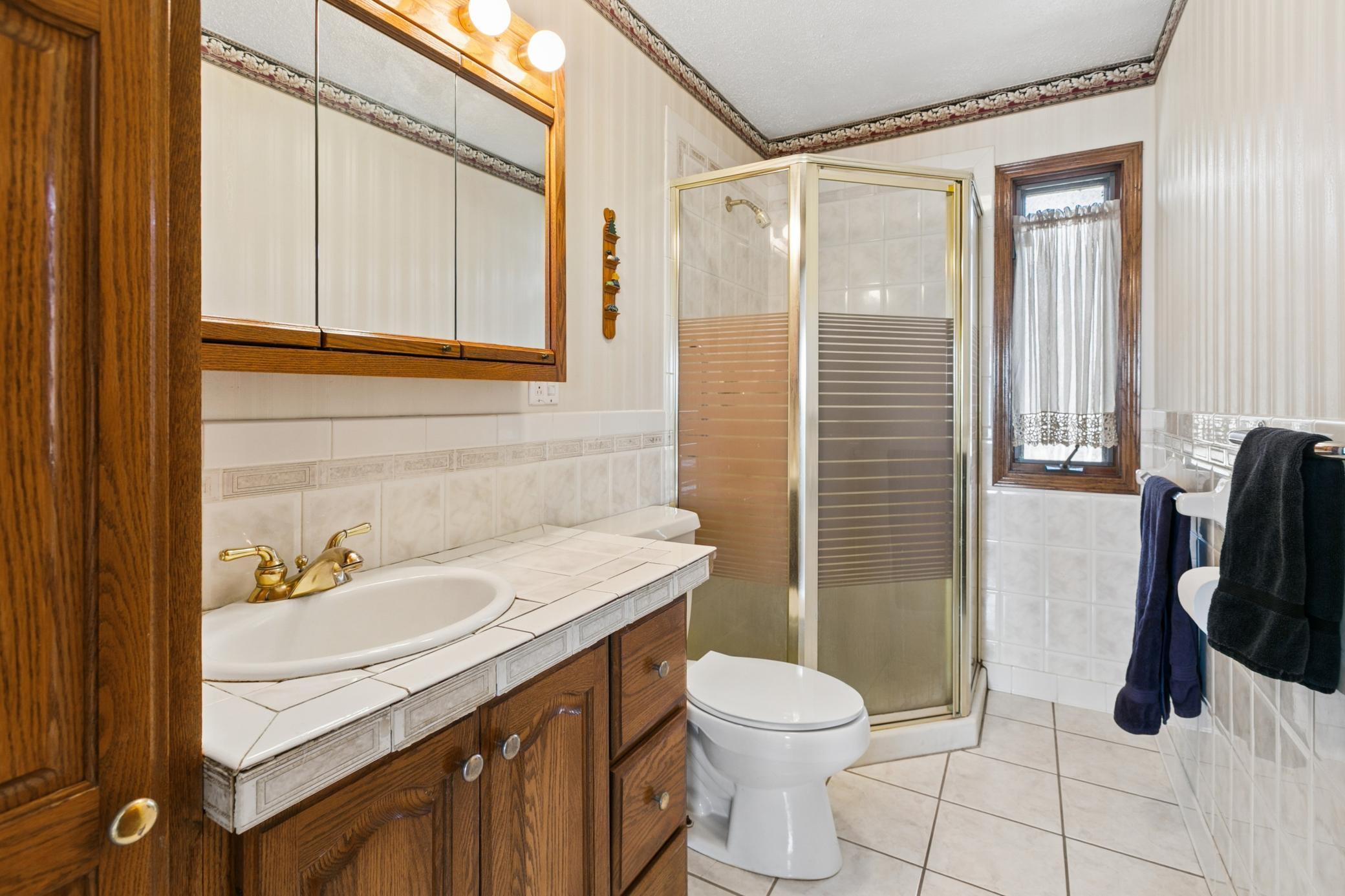 Three quarter bath on the main level with deep, floor to ceiling linen closet.