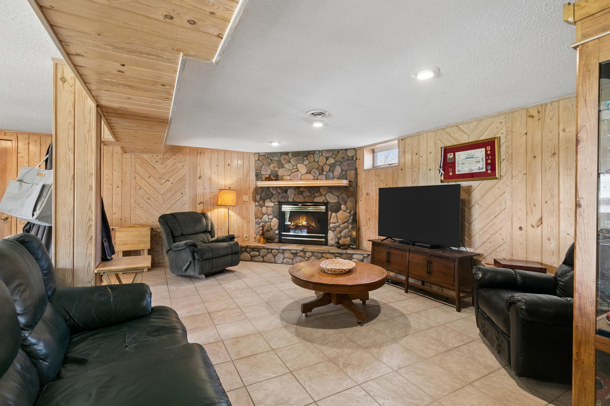 This lower, walk-out level is cozy and bright. Gorgeous stone, gas fireplace creates a warm and inviting space to hang out throughout the year.