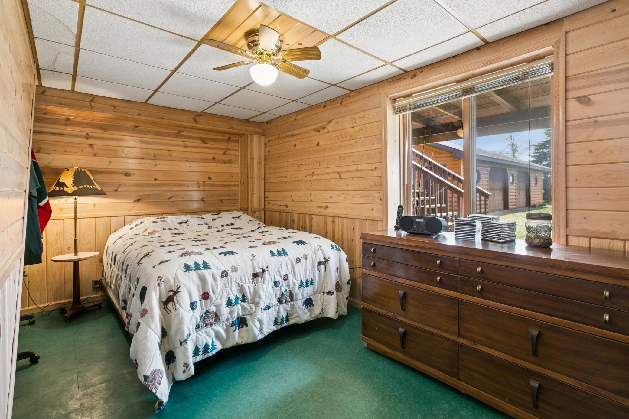 4th lower level bedroom with knotty pine finishes and views to the lake.