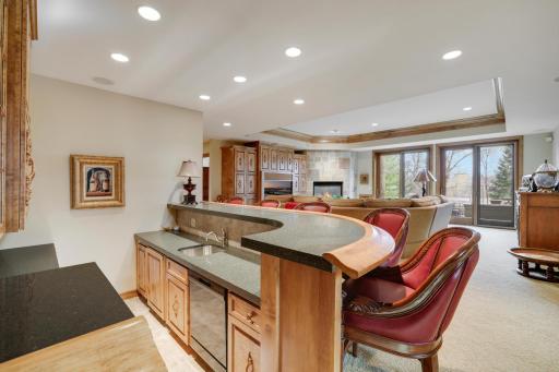 5 seat wet bar with ice maker, refrigerator and dishwasher. A near by wall wine refrigerator.