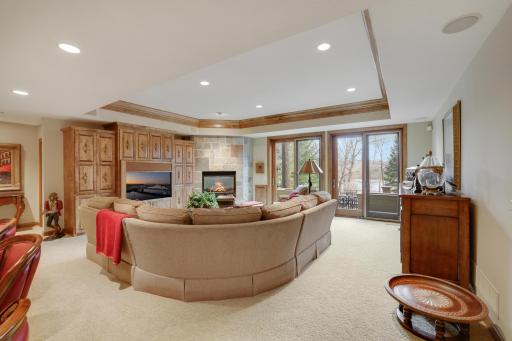 Lower level family room with gas fireplace, built in cabinets, and sunken wet bar.