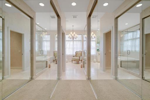 Sliding mirrored doors to walkin closets on way to primary bedroom bath.