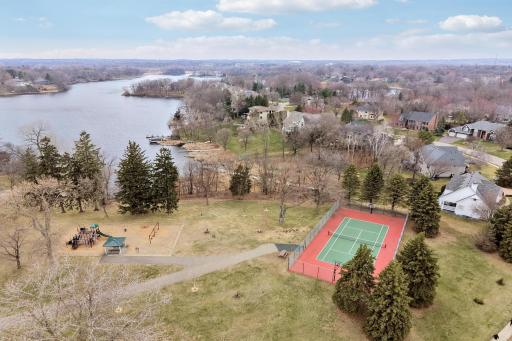 Red Rock Lake Park with tennis courts and kids play area. Parking spots and boat access.