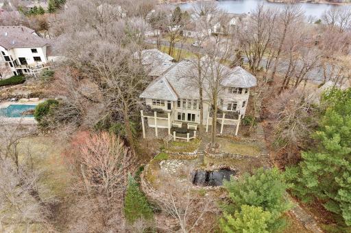 Privately wooded lot of over an acre on Red Rock Lake. Walkout lower level. Multiple decks and patio with Koi Pond. Fenced in rear yard.