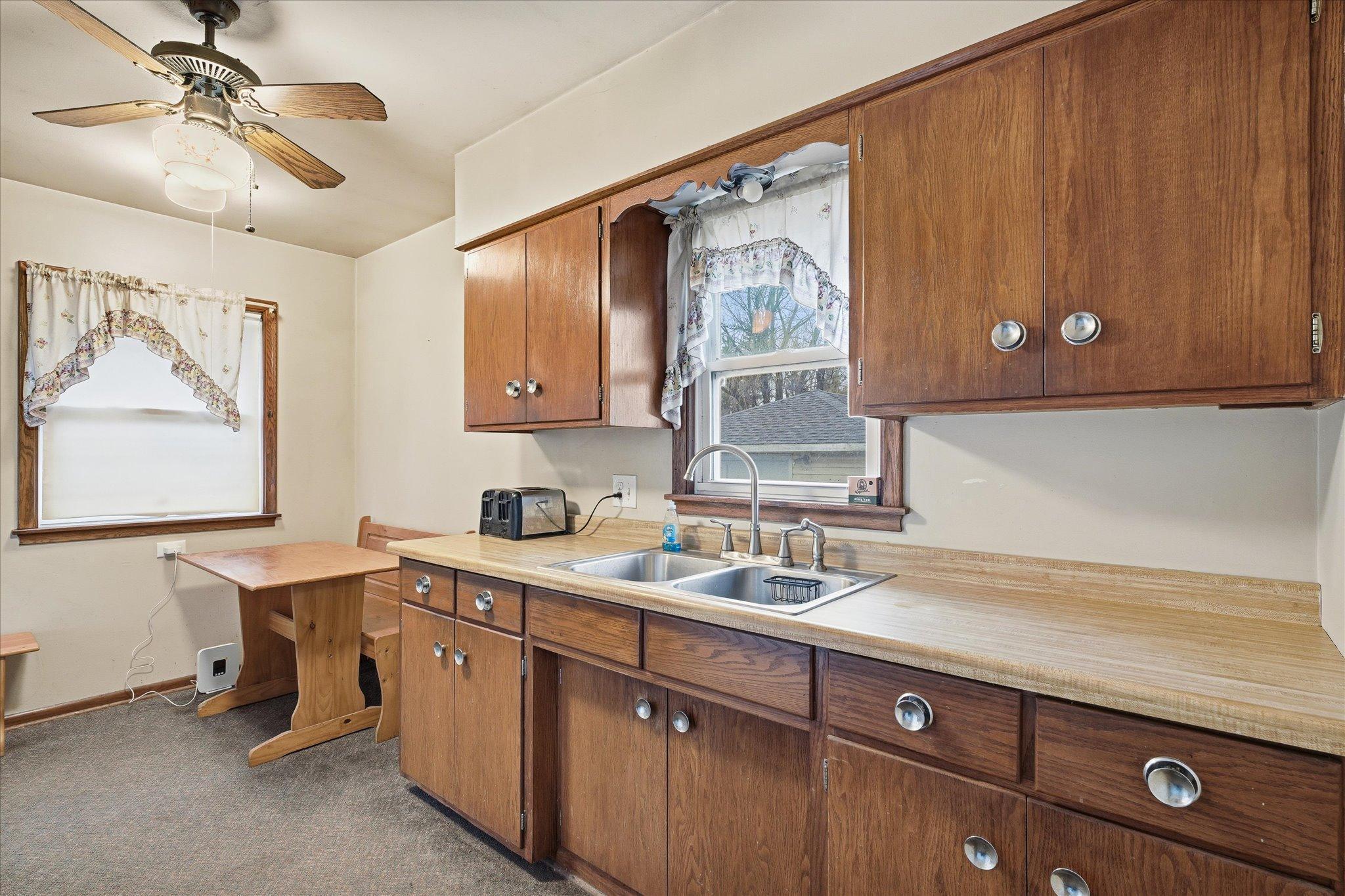 Kitchen with ample cabinet space, laminate countertops, and a functional layout.