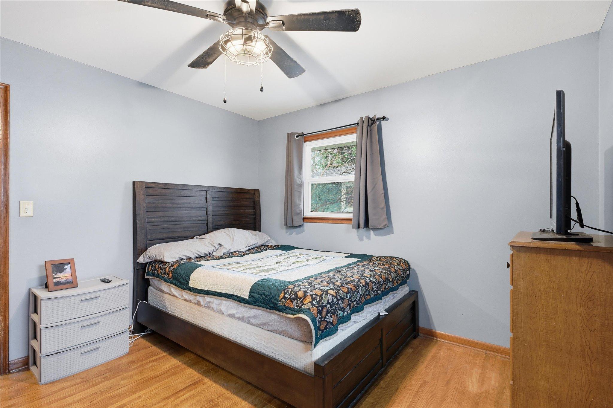Spacious bedroom #1 freshly painted with hardwood floors, dual windows, and great natural light, perfect for a relaxing retreat.