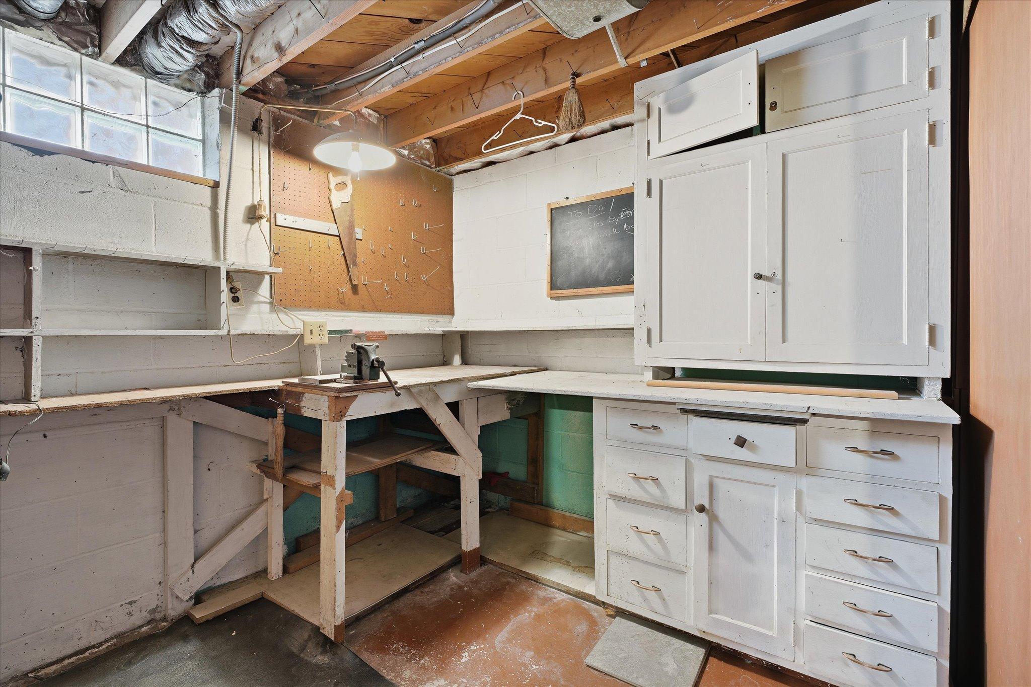 Workshop space with built-in workbench and storage, ideal for projects, tools, and extra organization.