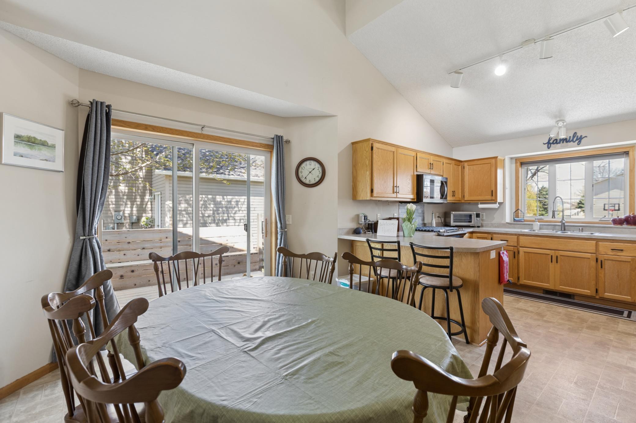 View of the Dining and Kitchen with the breakfast bar with room for 2. You will love the easy access to the kitchen as your bring in the groceries from the attached garage.