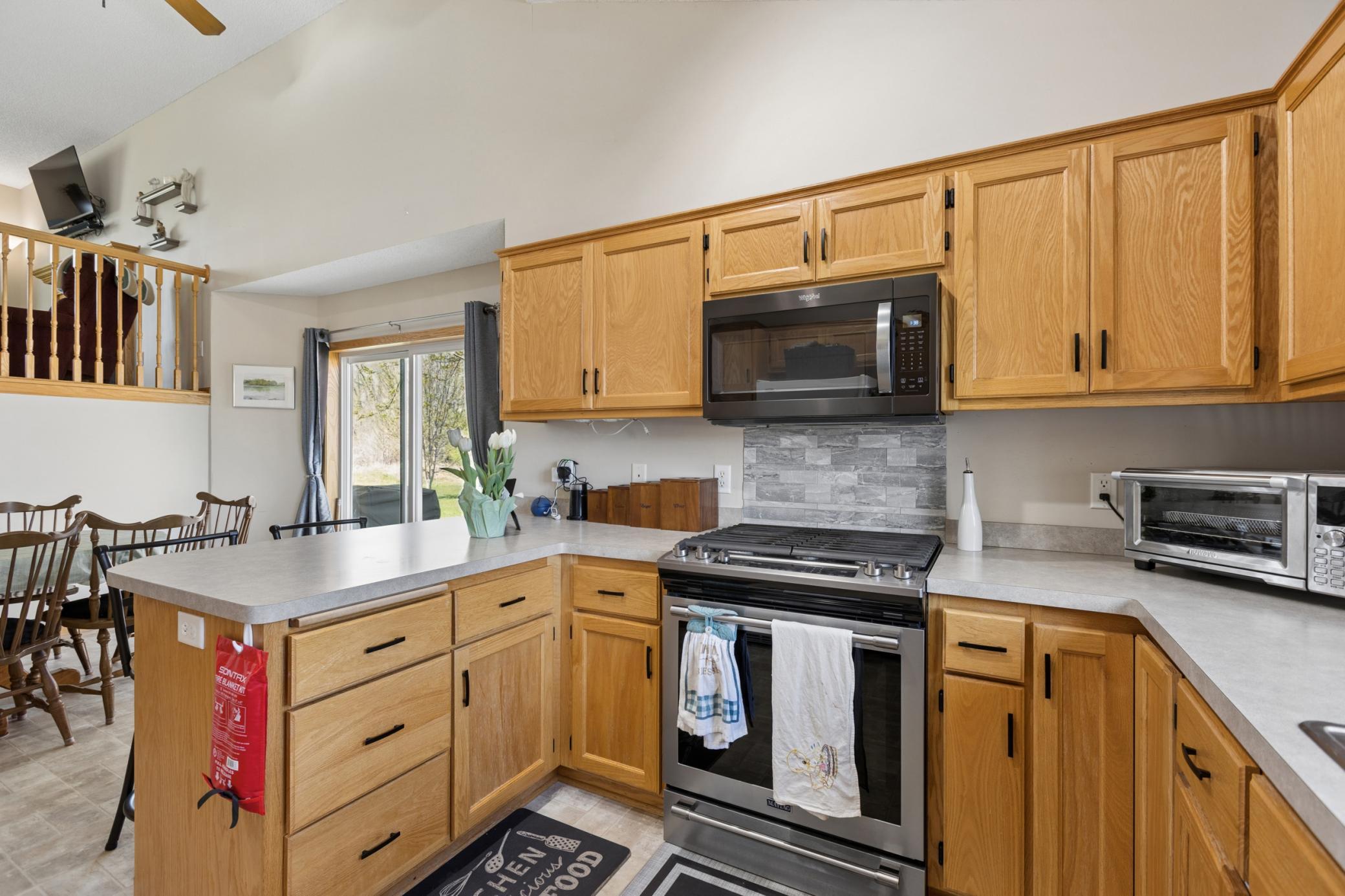Kitchen features newer, Stainless Steel stove, microwave and dishwasher.