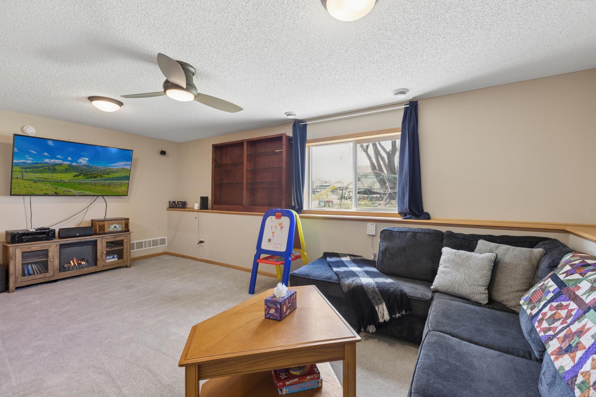 Lower level living room. So many options to relax entertain, movie night or game day. Perfect for your family. You can even enjoy the sunsets from your own living room.