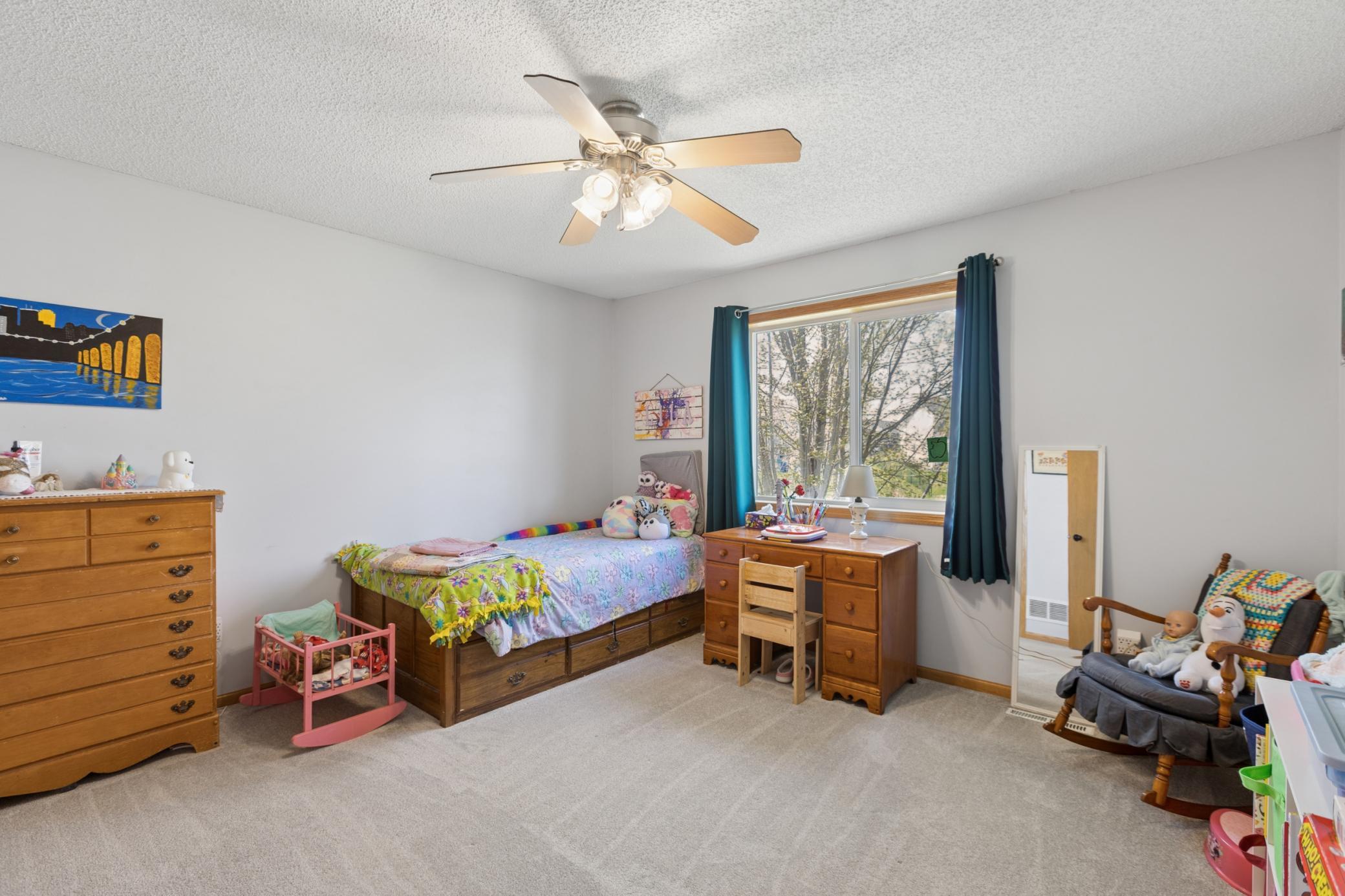 Bedrooms feature ceiling fans and great windows for lots of light and views overlooking the large backyard and pond.