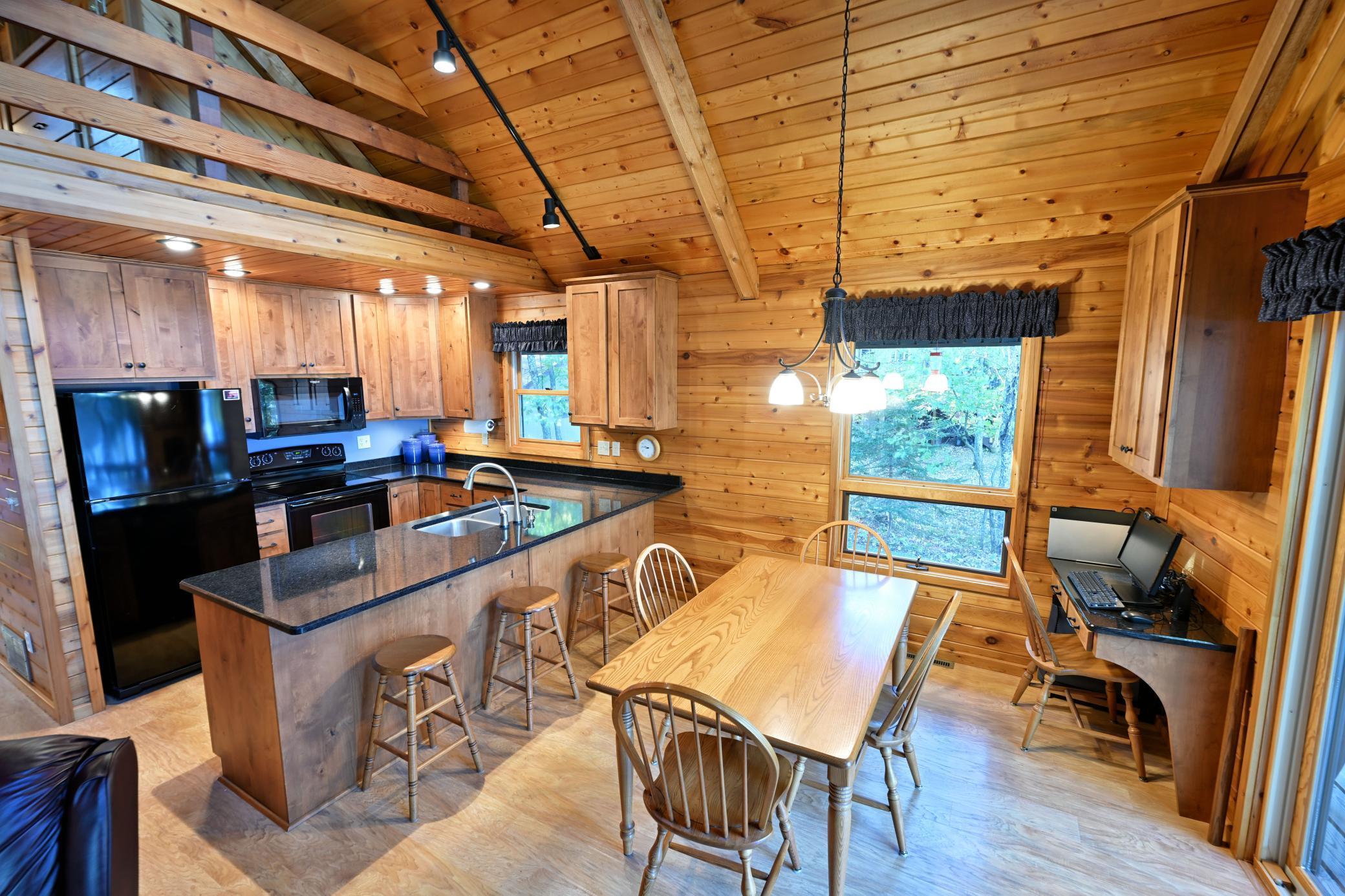 The kitchen and dining area includes a breakfast bar and desk nook.