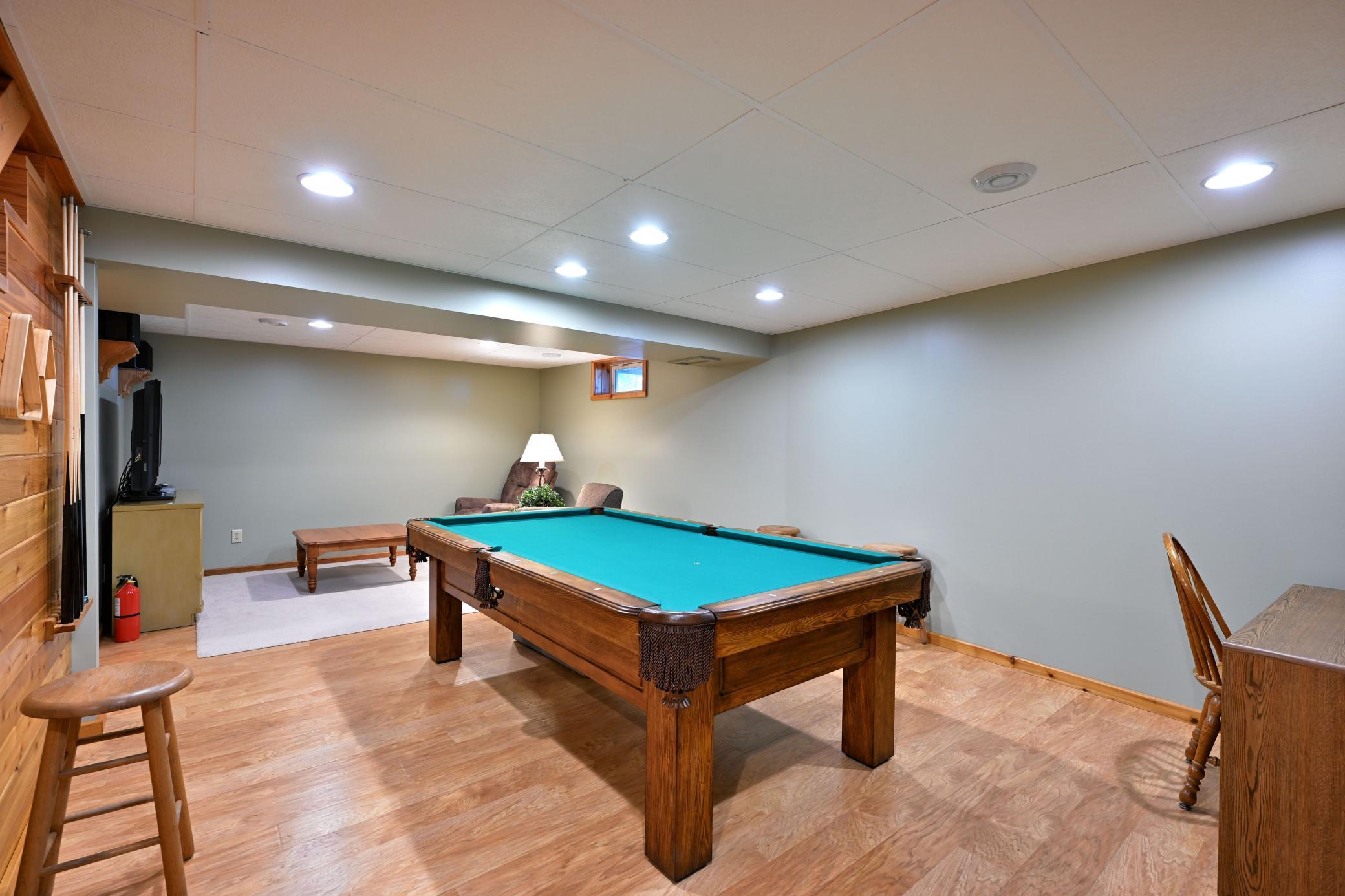 The family room has multiple activity areas for winter or rainy days. The pool table is included in the sale of the home.