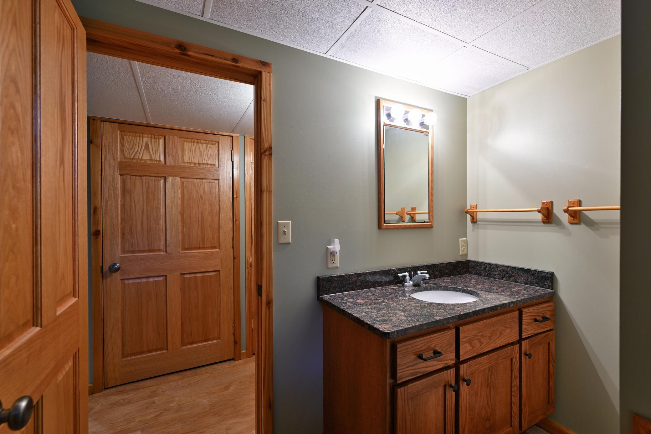 The bathroom has a granite topped vanity.