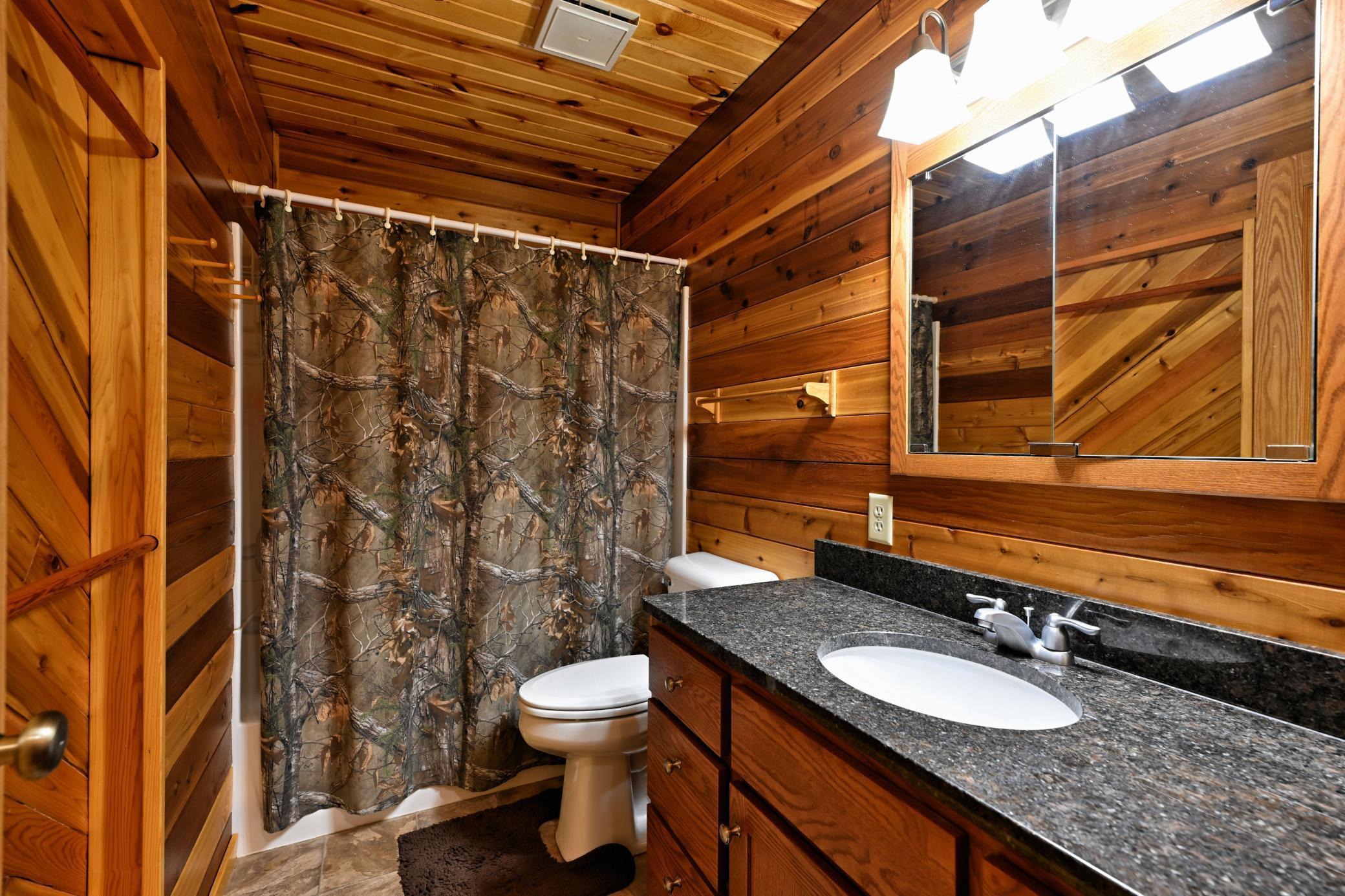 The main level has a full bath with a long granite topped vanity.