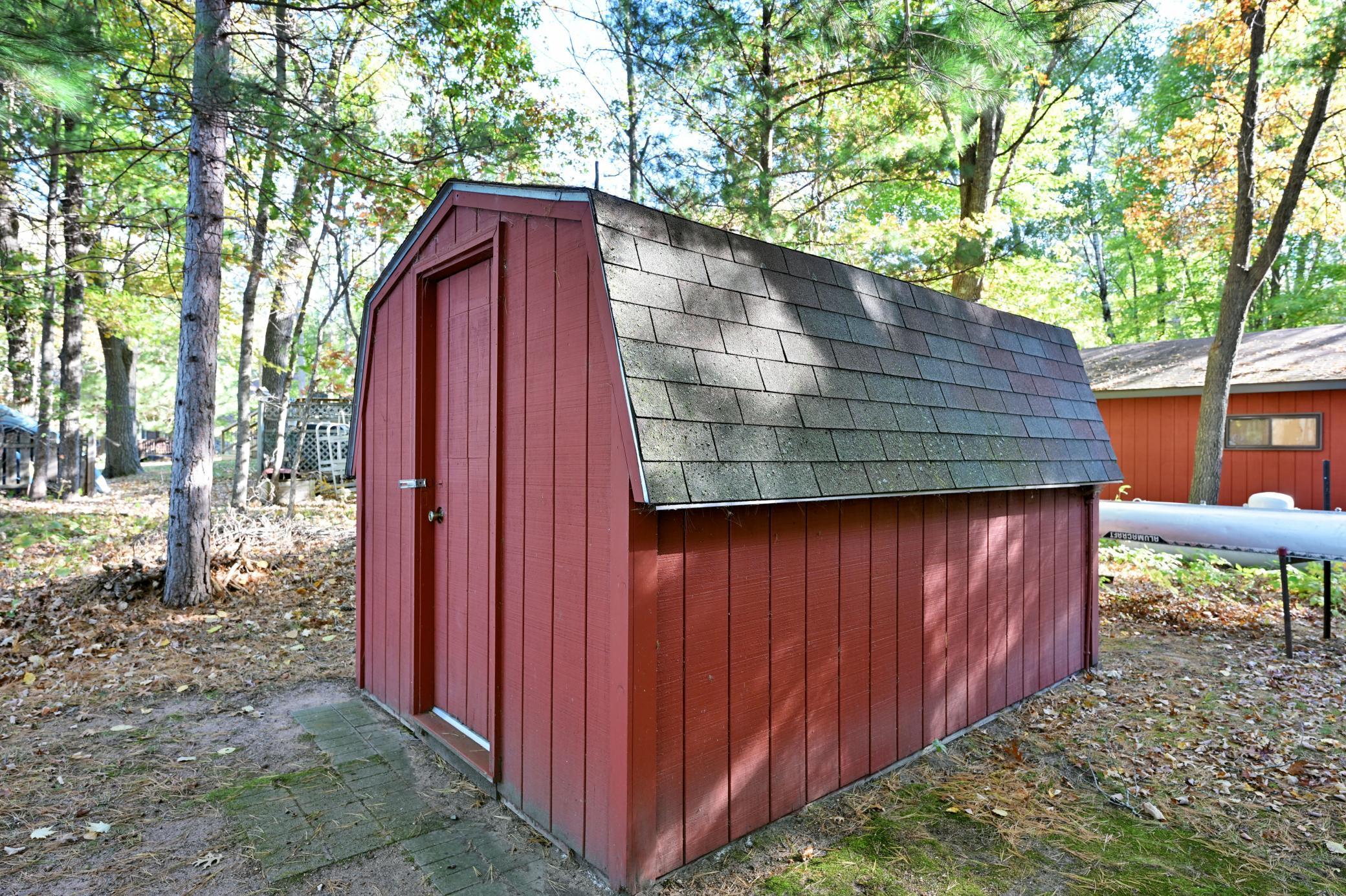 A garden shed provides storage for yard items.