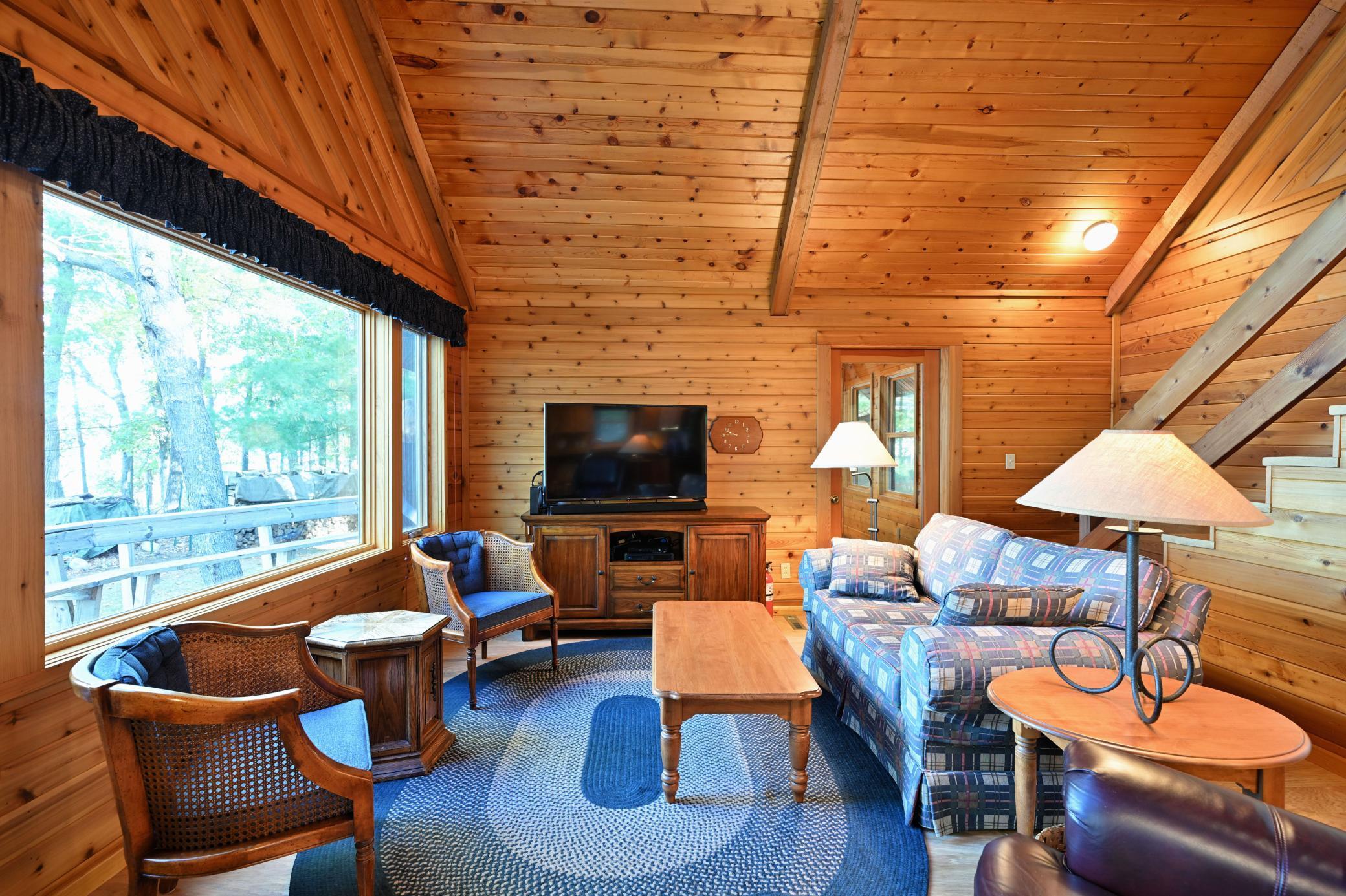 The living room has lake views and there is a three-season porch adjacent for additional seating space.