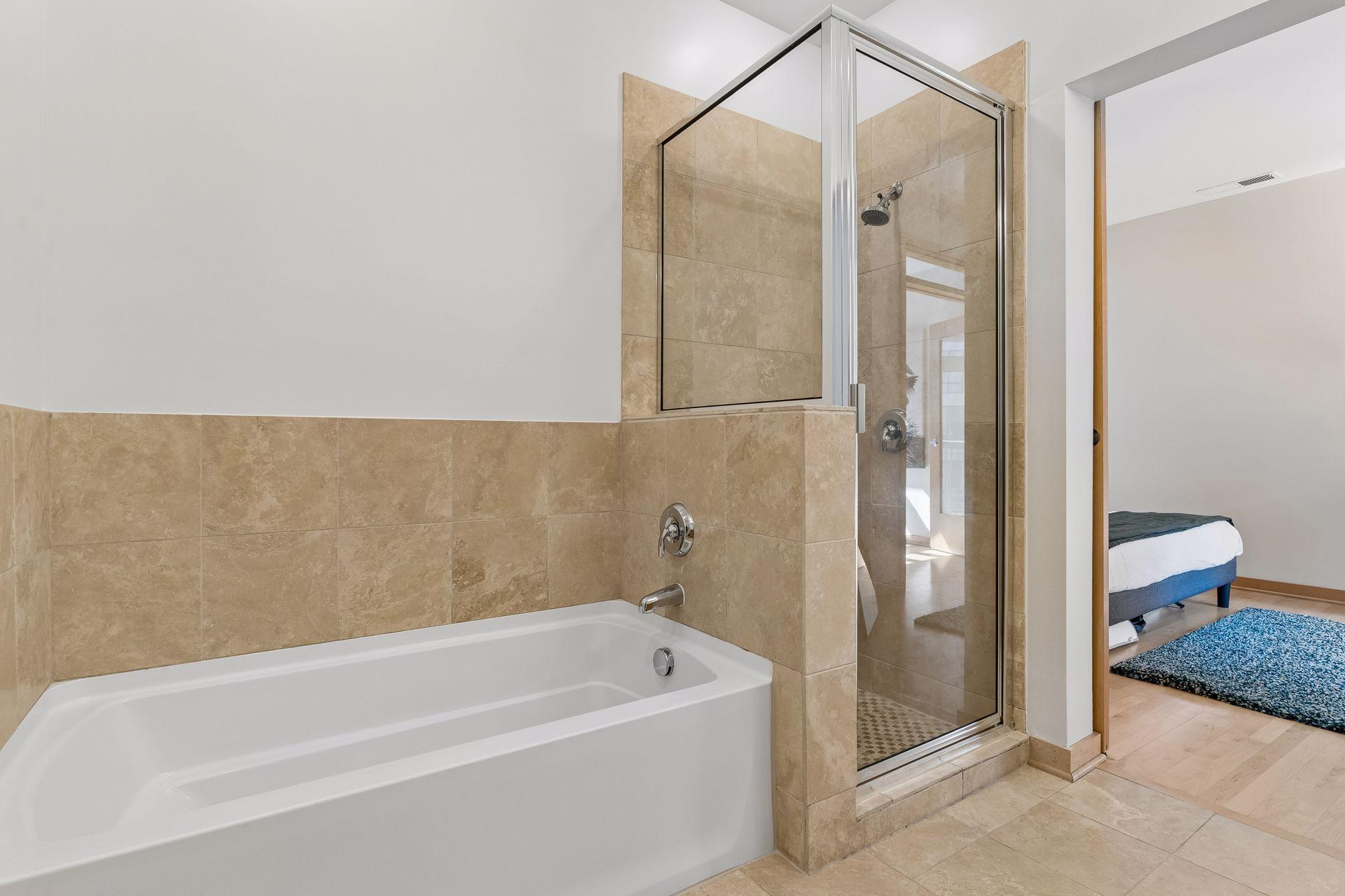 Soaking tub and separate step-in shower in the primary bath.