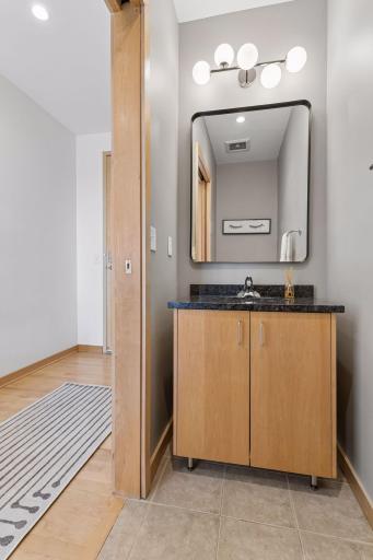 Powder room with granite vanity and updated lighting.