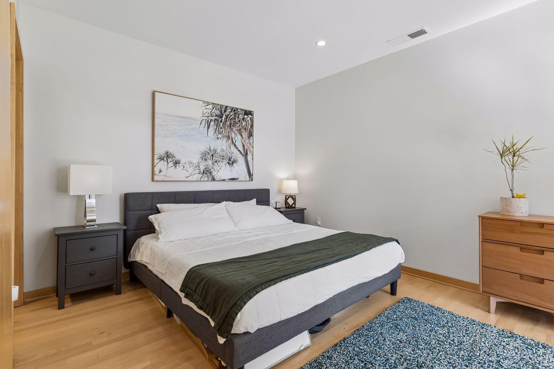 Primary bedroom with recessed lighting and hardwood floors.