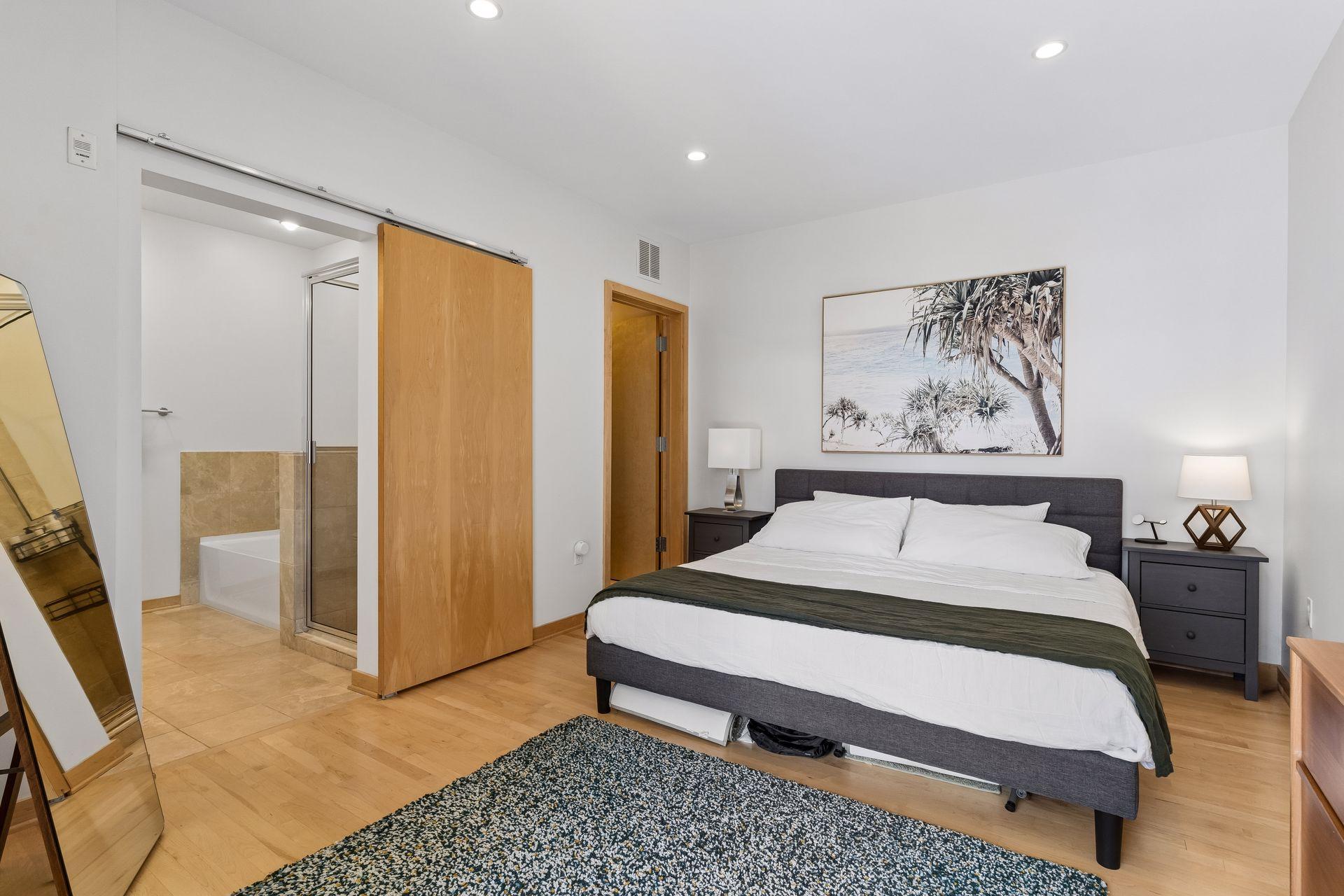 Primary bedroom with spacious ensuite bath and walk-in closet with full sized washer and dryer.