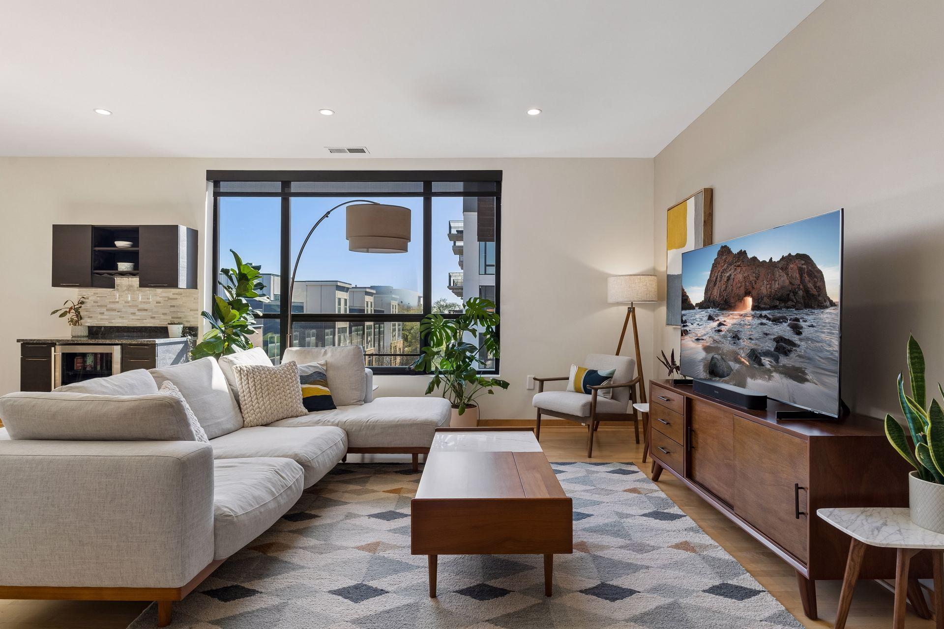 Cozy living room filled with natural light in the morning and sunset on the opposite side of the building, which works great for unwinding at the end of the day.