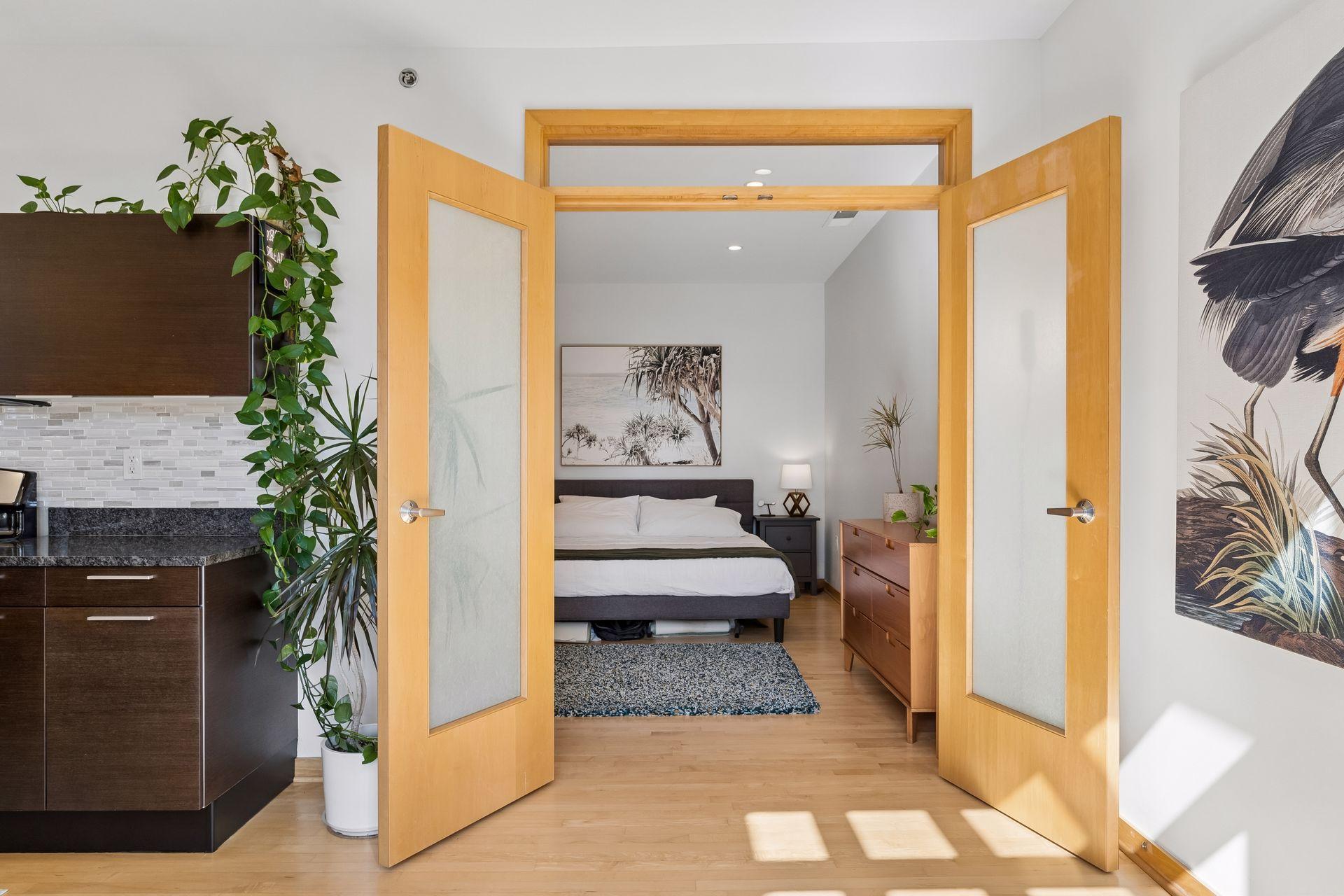 Large primary bedroom with french doors and transom window.