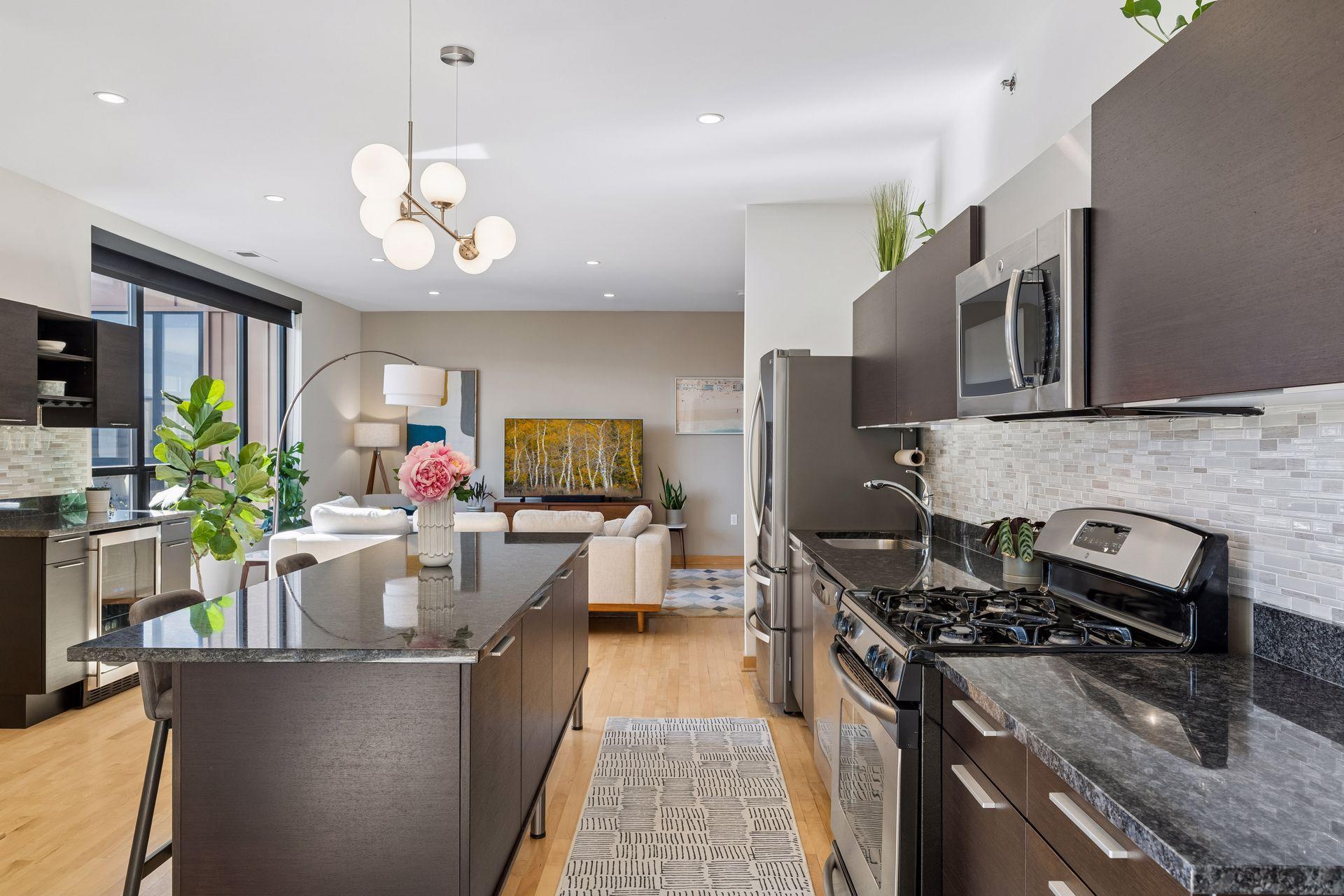 Large kitchen center island provides breakfast bar seating, and storage for pantry and appliances.