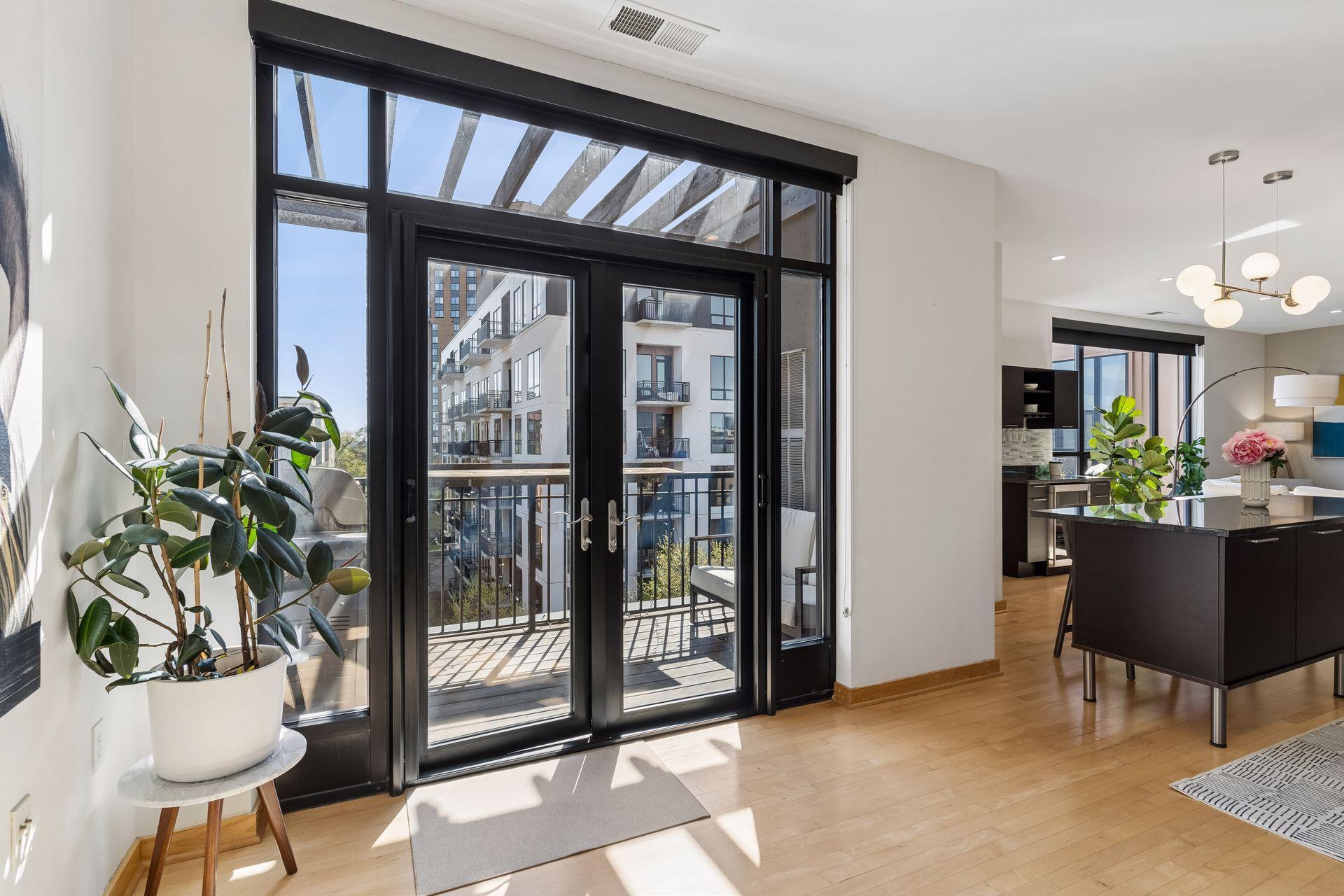 Double steel French doors, with transom window and sidelights, provide natural light year-round.