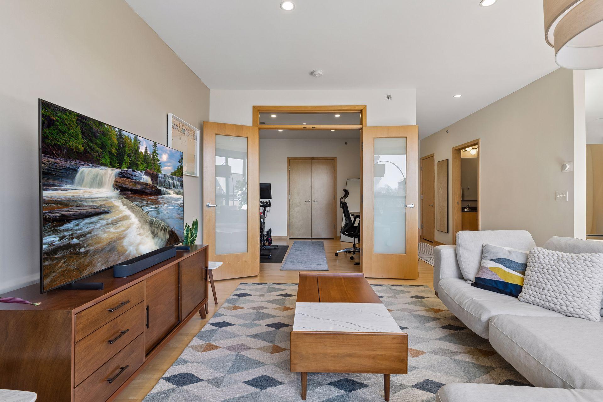 Bedroom or flex space off the living room with frosted glass french doors.