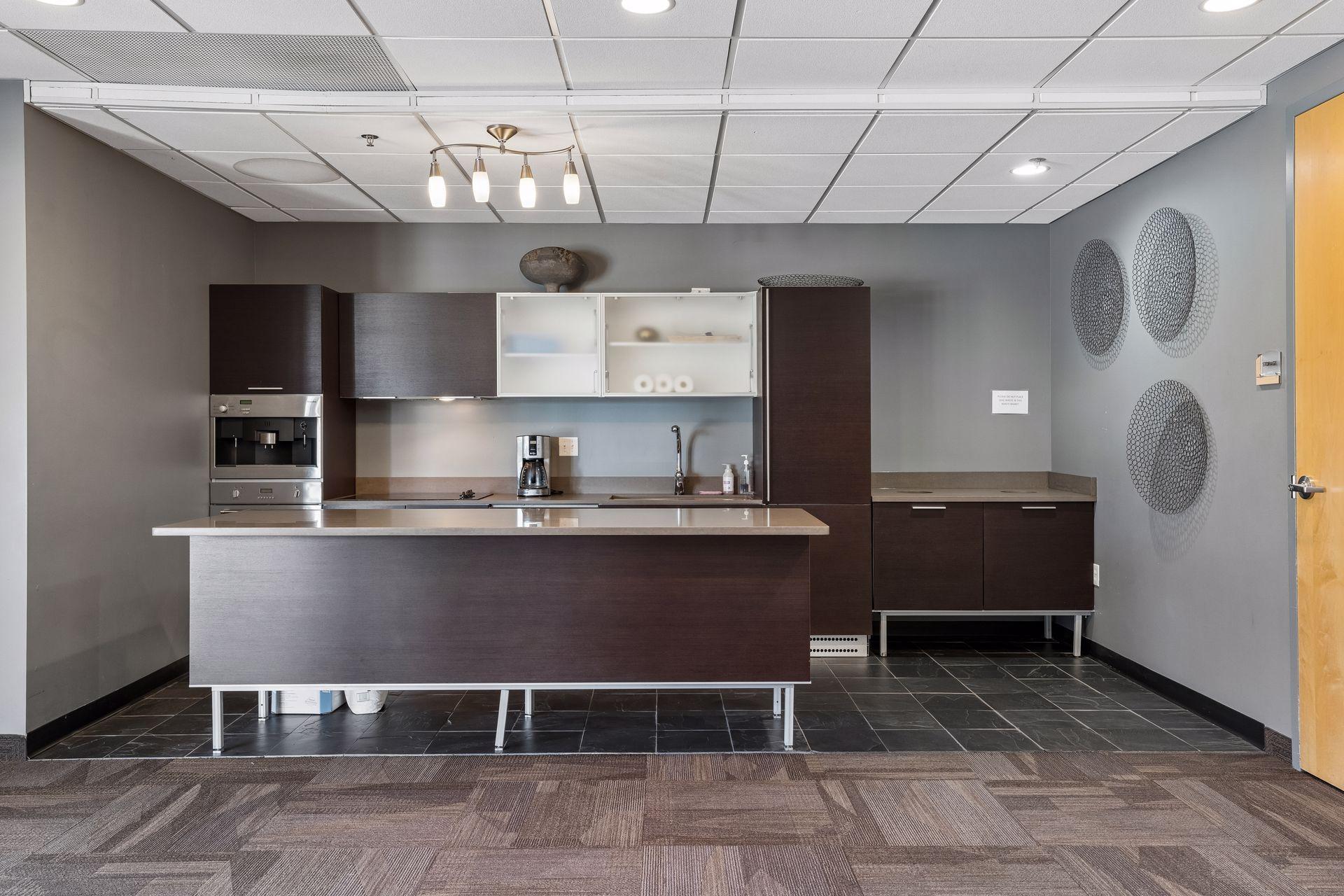 Community room includes and espresso machine, sink, oven and coffee maker, and HDTV.