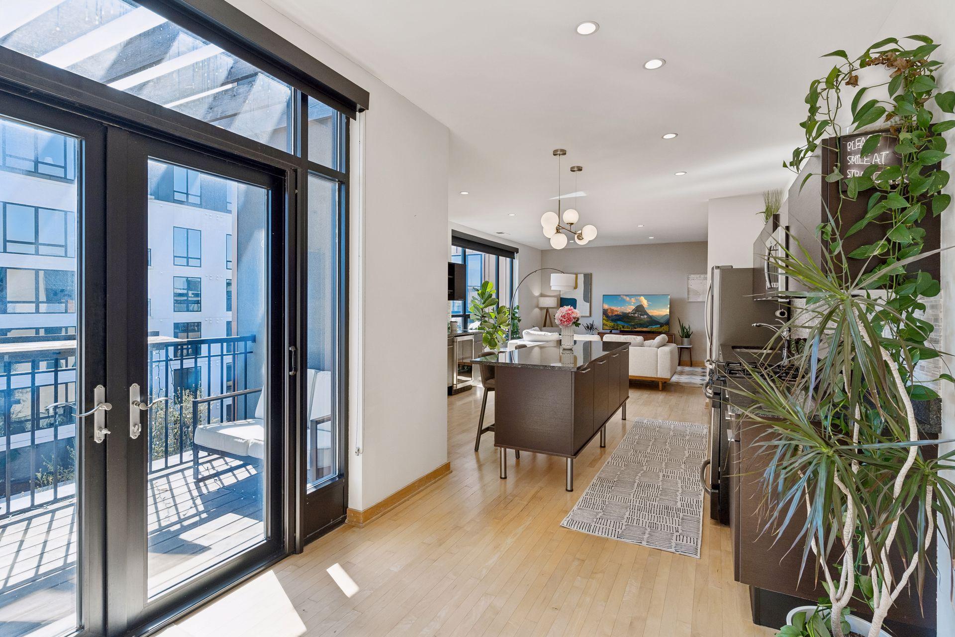 Glass french doors open to the East-facing private balcony for morning sun.