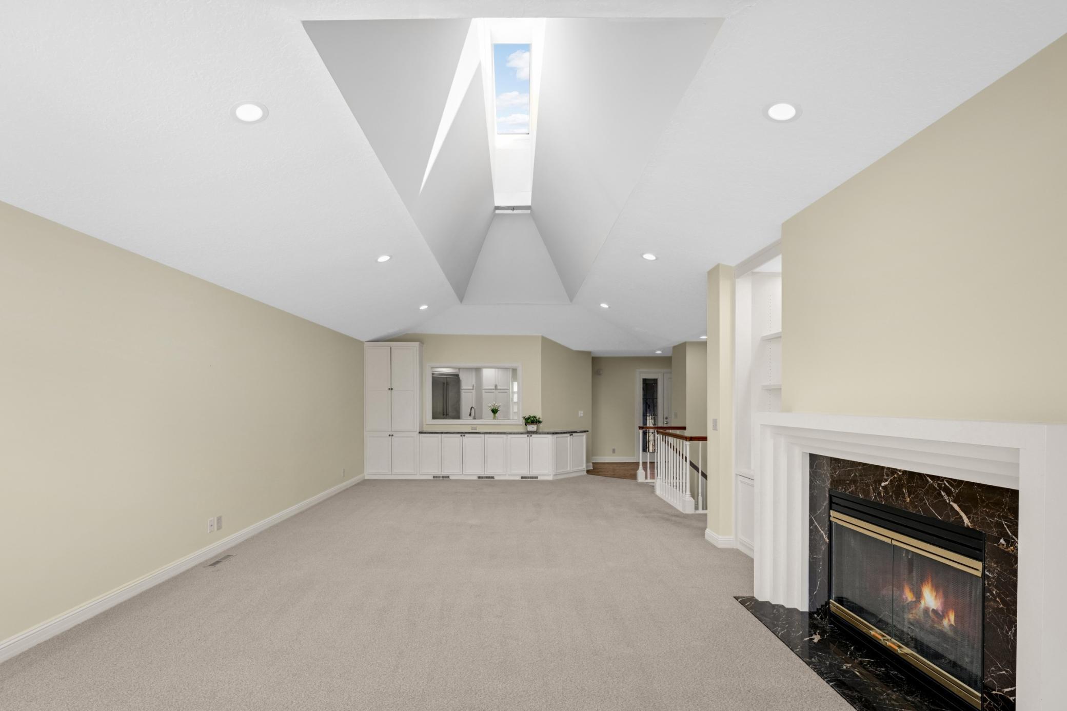 The spacious dining room has room to expand your table for larger gatherings and has a wall of built-ins and granite buffet.