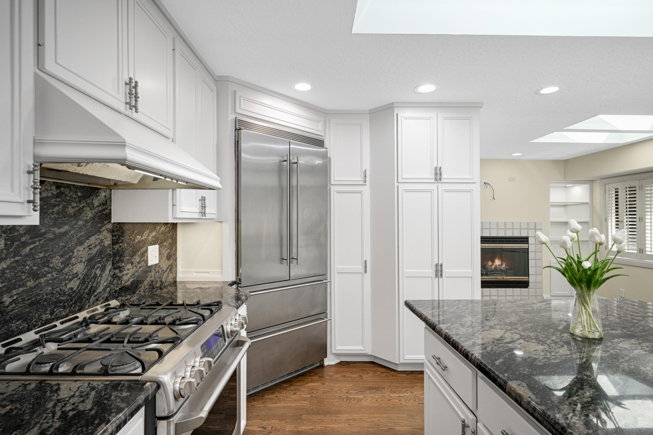 The kitchen is a chefs delight and offers a gas range, 3 ovens an abundance of cabinets to the ceiling and opens to a large dining/sitting area.