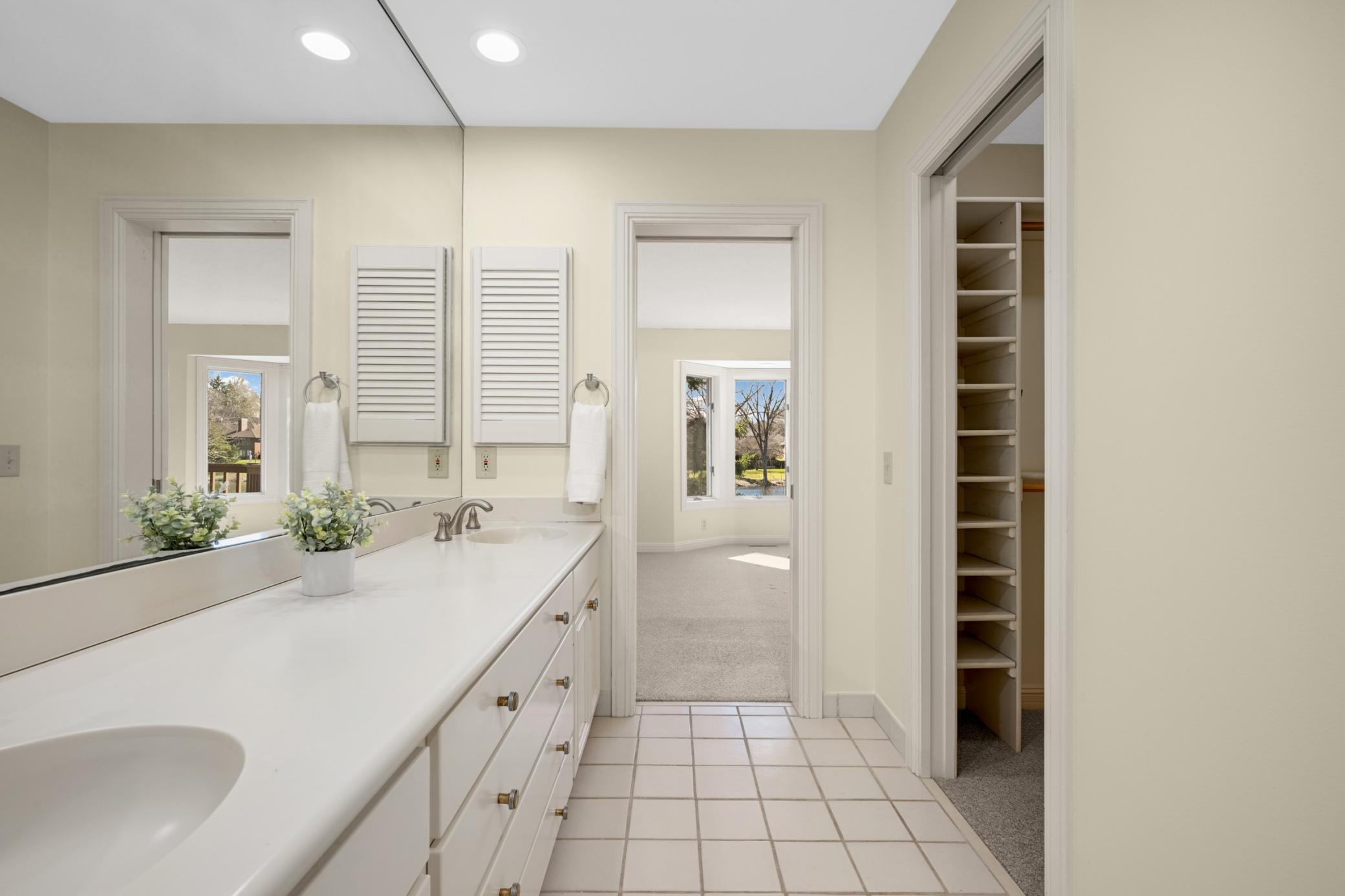 The luxurious primary bath offers an abundance of cabinets, dual vanities and a 2nd closet.