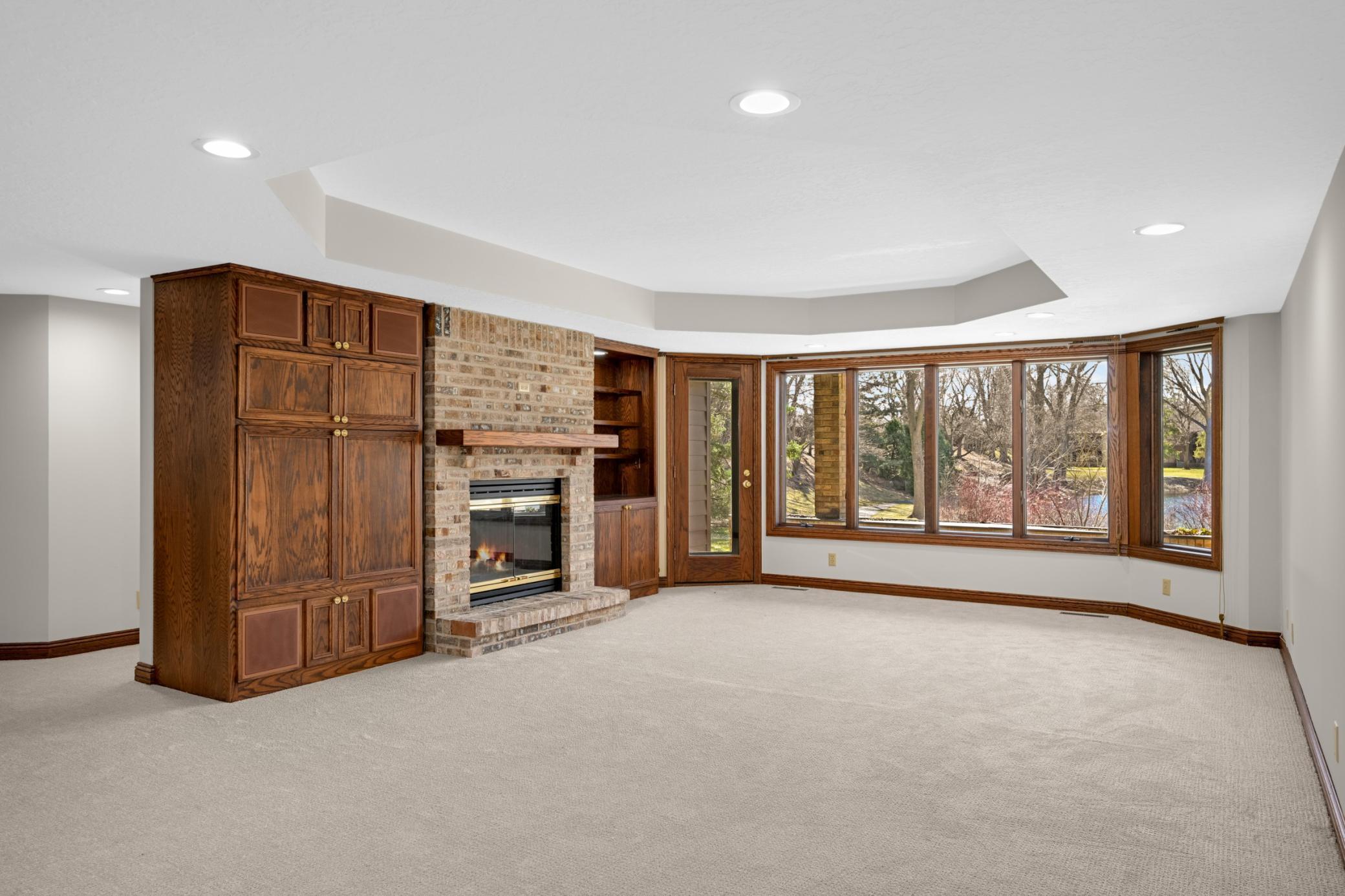 The walkout level family room is great for entertaining or having the grandkids over. Features a wood burning fireplace and built-ins and door to the patio.