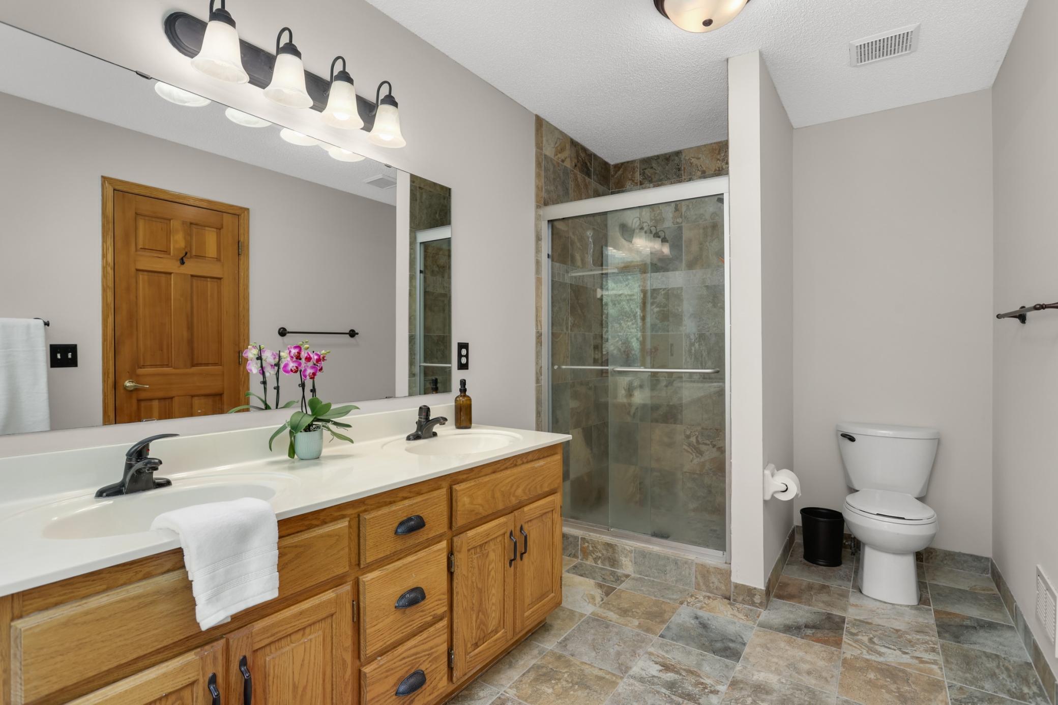 Primary bathroom with dual vanity and walk-in shower