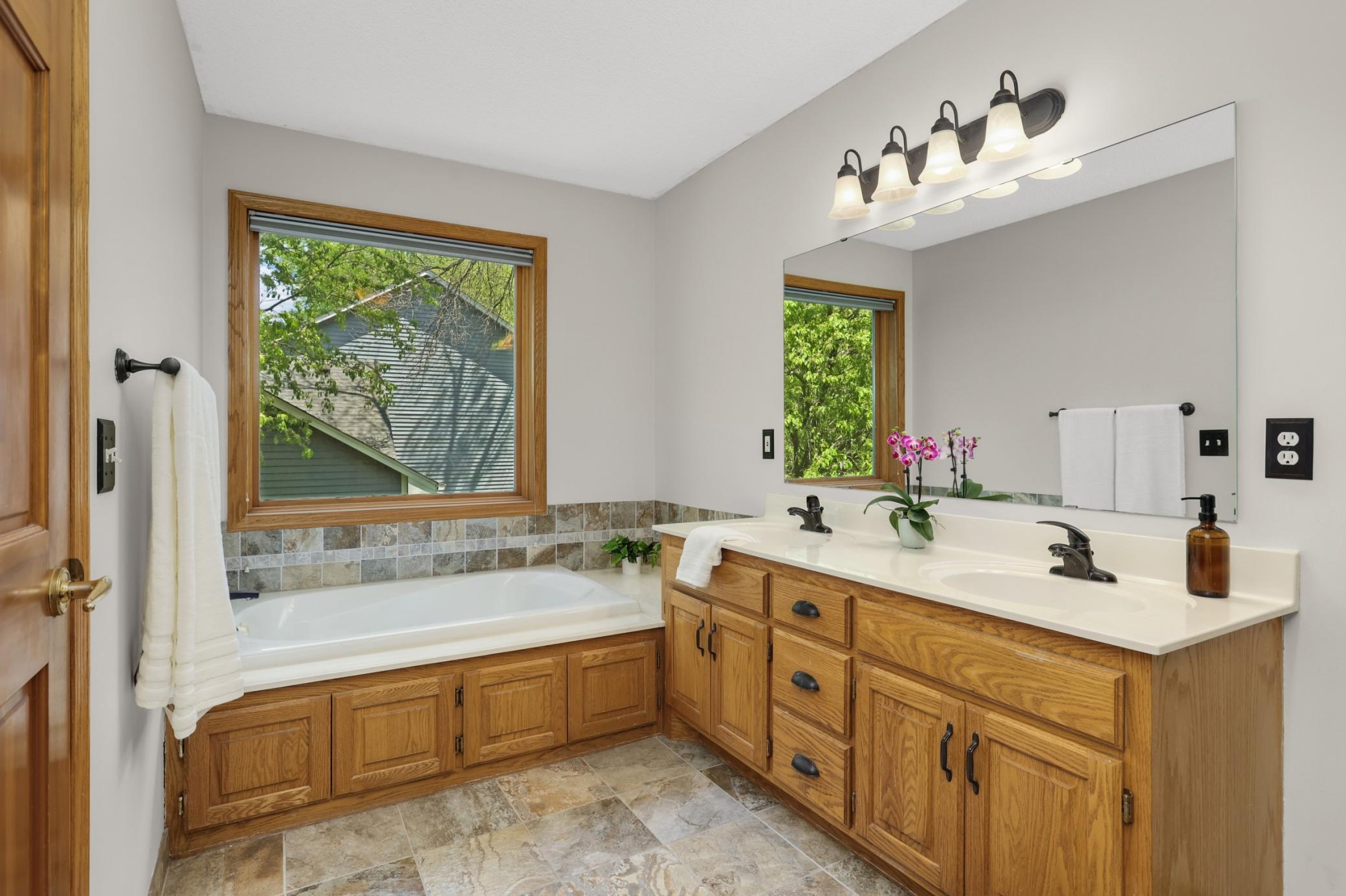A jetted tub completes this spacious and well designed primary bathroom