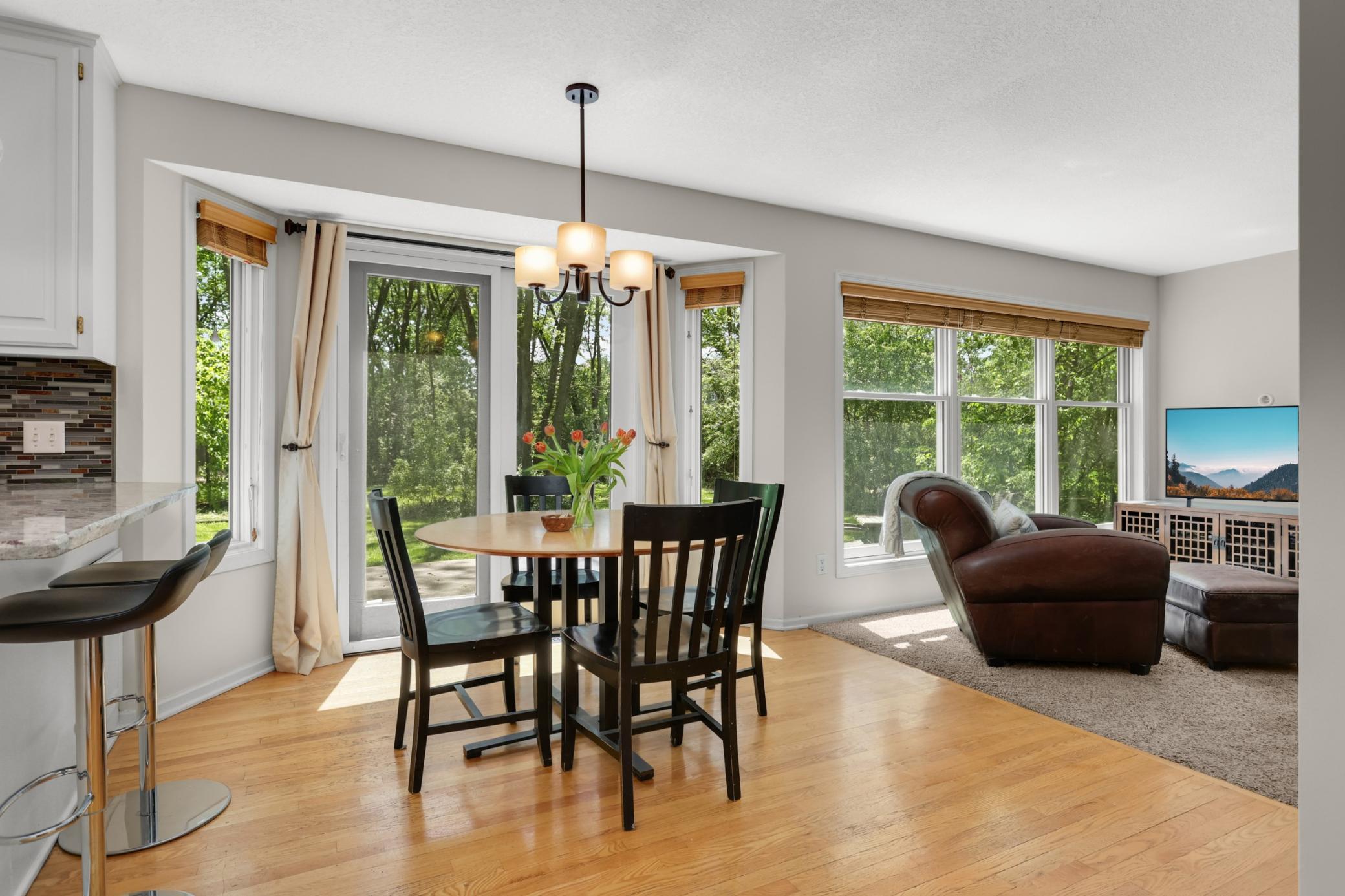 Open concept living spaces overlooking private backyard