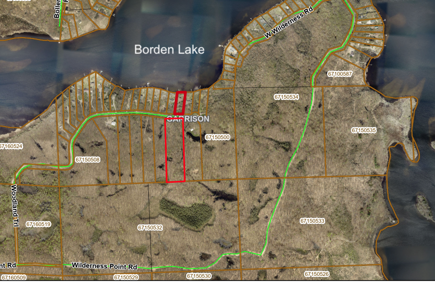 1 acre lake lot with additional 5.6 acres across Woodland Trail